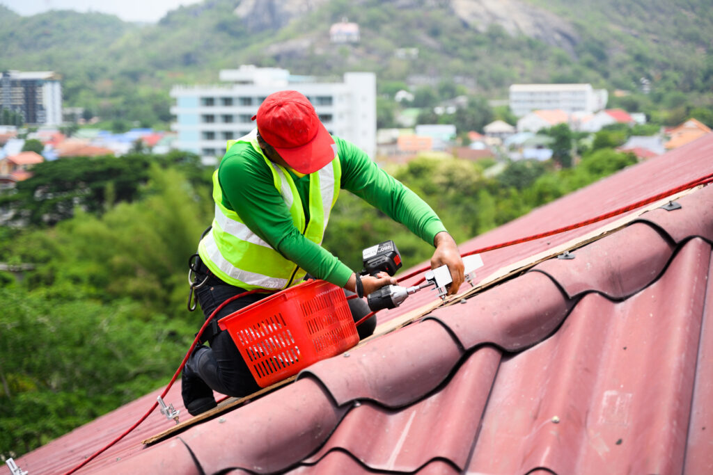 Professional engineer worker installing Shingles on rooftop,